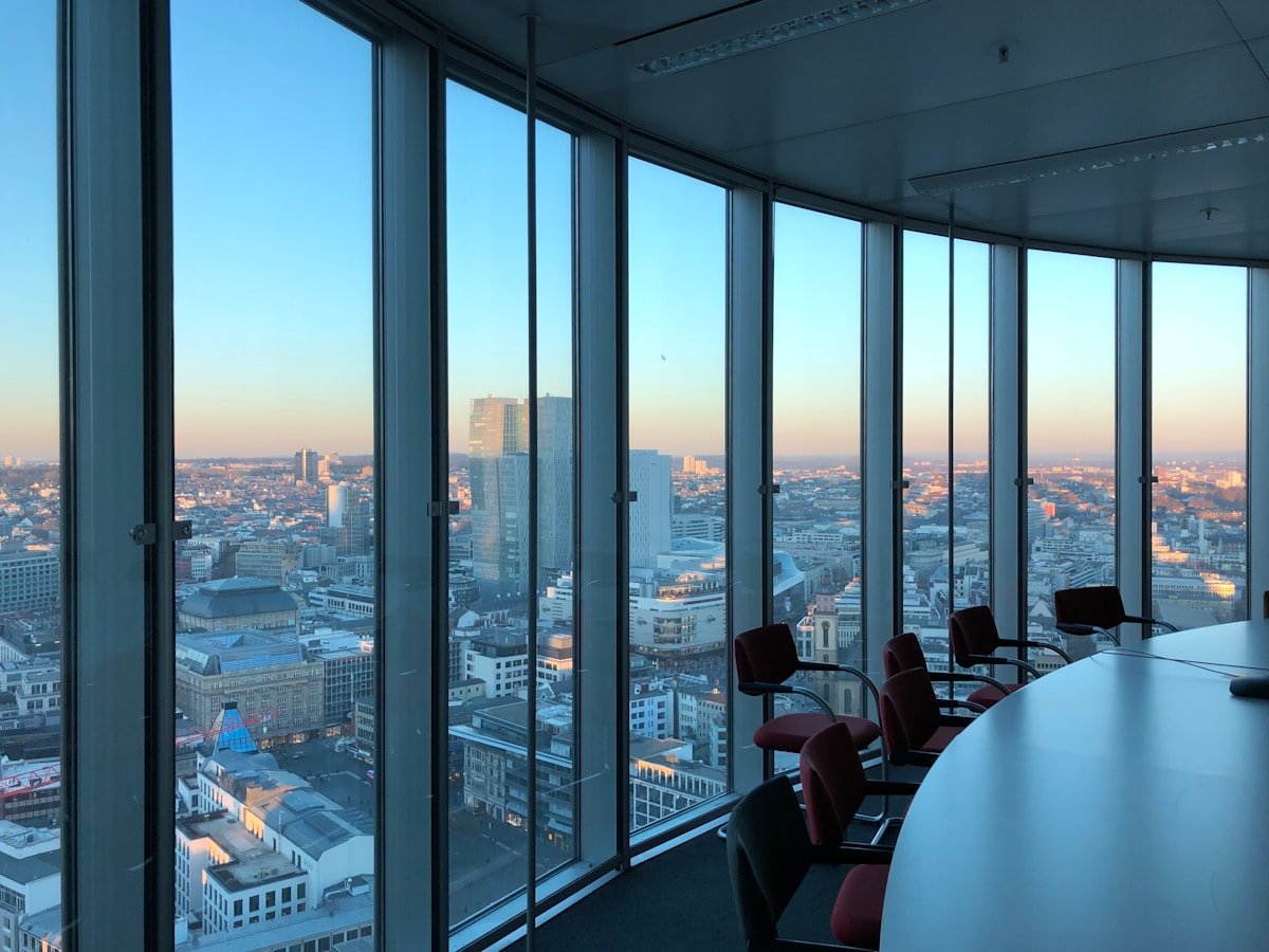 City skyline at dusk from a corporate boardroom