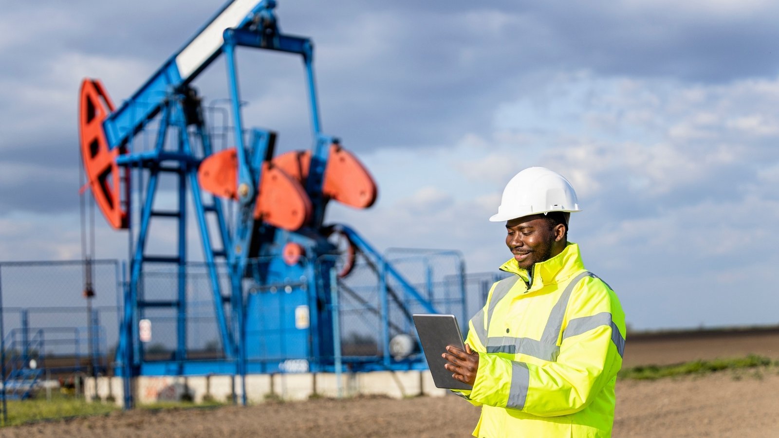 An energy engineer reviewing data beside field equipment, representing on site and distributed generation behind the meter.